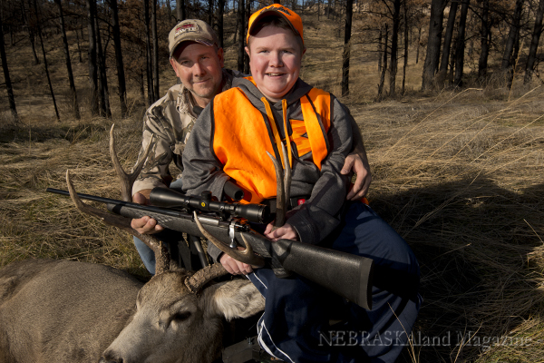 Garrett and his dad, Dave, pose with the buck.
