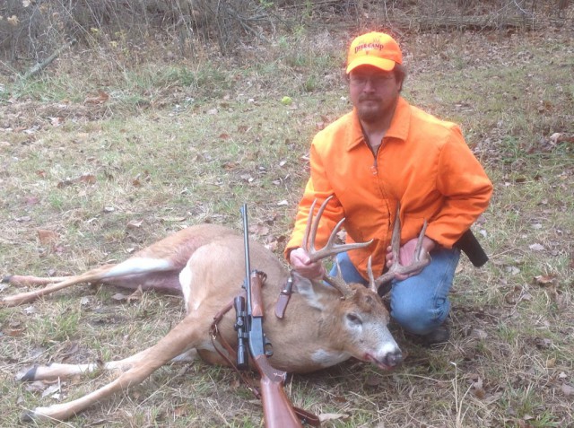 Dave with his buck, his uncle's rifle and his grandfather's knife...a proud moment