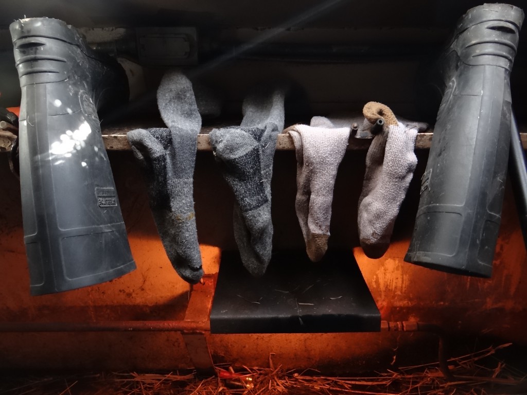Wet boots, socks drying in blind over heater.