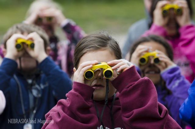 Lillie Schmidt of Gordon and other children try out binoculars during a bird watching activity at Chadron State Park. Three birding hikes are scheduled at parks throughout the Panhandle on Saturday. (NEBRASKAland/Justin Haag)