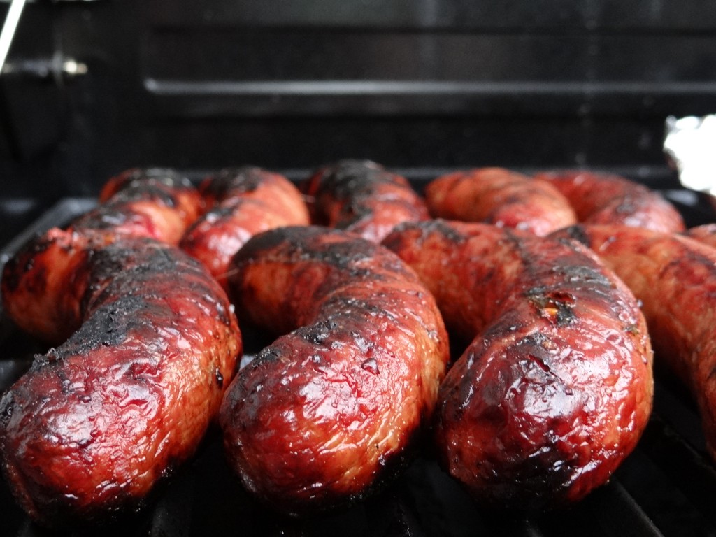 Venison sausages on the grill. Photo by Greg Wagner.