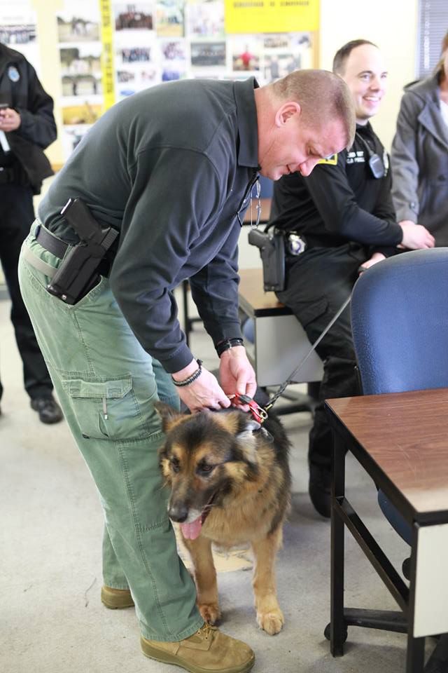 Omaha Police Sgt. Matt Manhart with a retiring bomb-sniffing dog. Photo Courtesy of the Omaha Police Department.