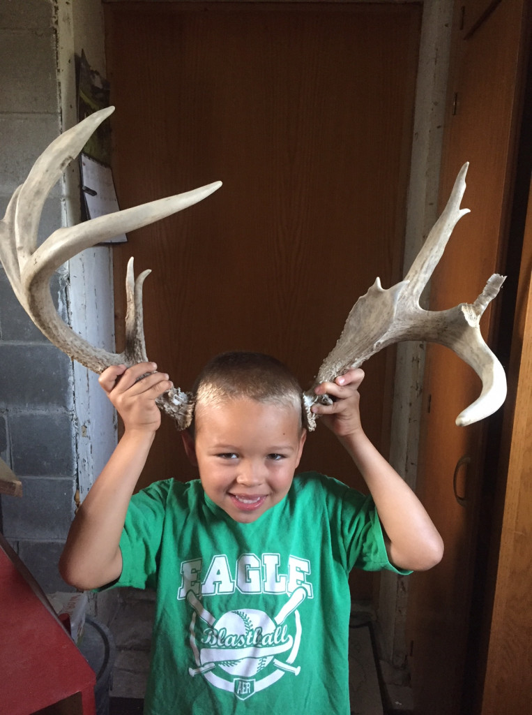 Kyler showing off a set of antlers he found while on exploring the pastures. He is still on a mission to find this deer