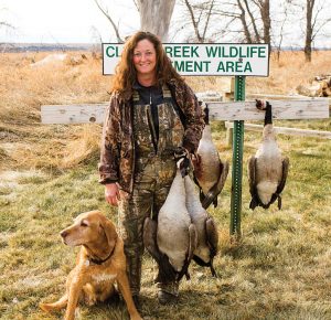 Julie Geiser and her Labrador retriever, Berkley, after a great day of goose hunting last year at Clear Creek WMA.