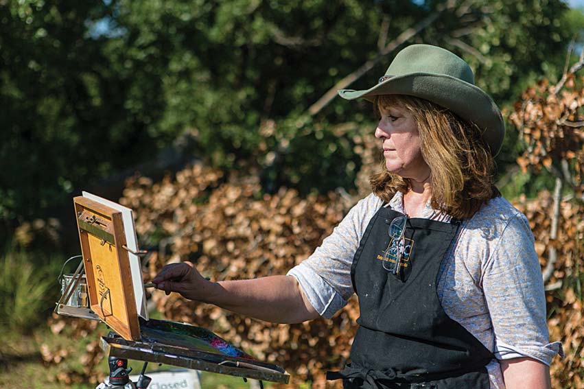 Debra Joy Groesser is president and CEO of the American Impressionist Society and has painted en plein air since 1997. She is pictured above painting on-site at Spring Creek Prairie Audubon Center.