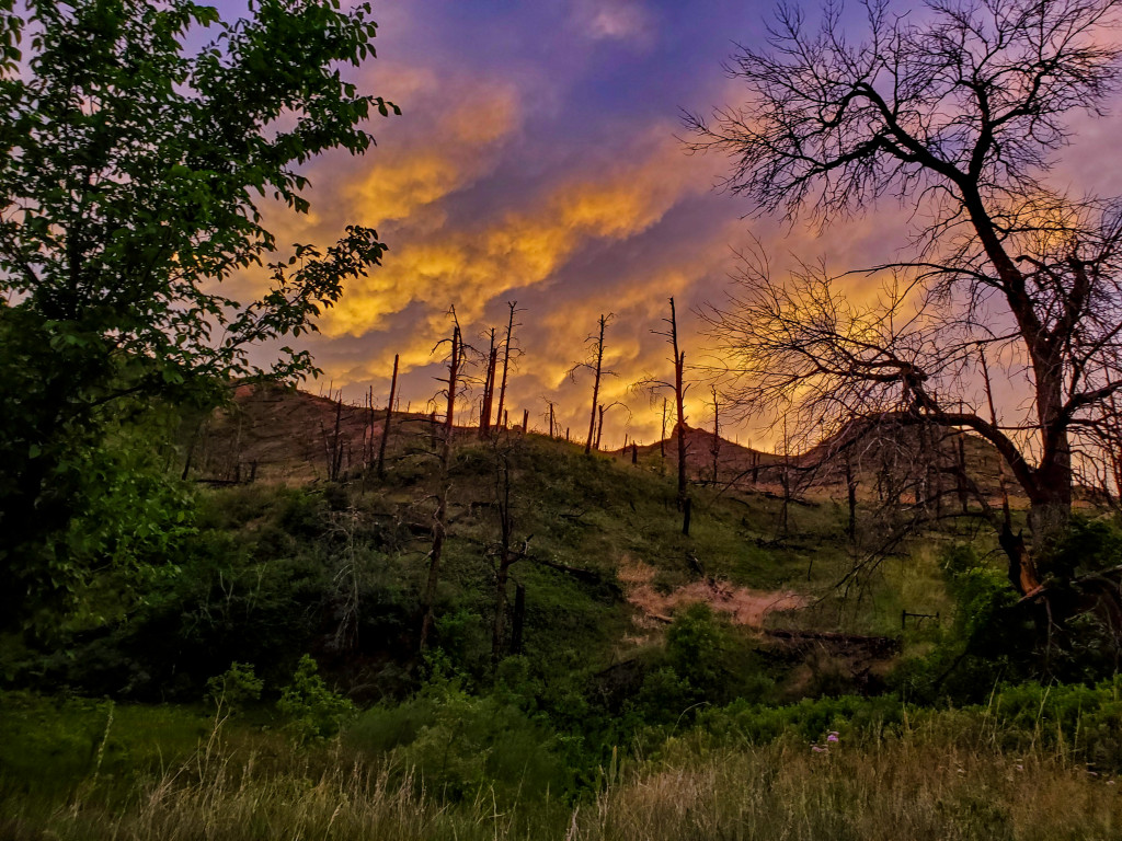 Clouds glow above East Ash Creek Canyon at sunrise.