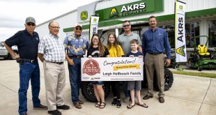 From left, Bob Allen, Nebraska Game and Parks commissioner; Jim Douglas, Game and Parks director; Rick Brandt, commissioner; Jody Hellbusch; Kaylee Hellbusch, 12; Leigh Hellbusch, winner of the Take 'em Hunting grand prize; Connor Hellbusch, 10; and Kent Kirchhoff, vice president of sales and marketing with AKRS Equipment, during a ceremony June 24, 2021, at the AKRS store in Gretna, Nebraska. | Jeff Kurrus, Nebraskaland, Nebraska Game and Parks Commission
