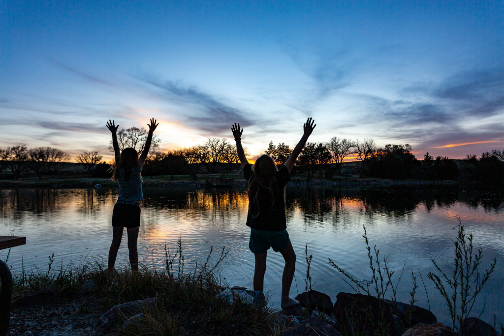 Paislee Erickson, right and Elyn Bargmann reach for the last light of the sun from one of the fishing nodes. The nodes are great for picnicking as well.  