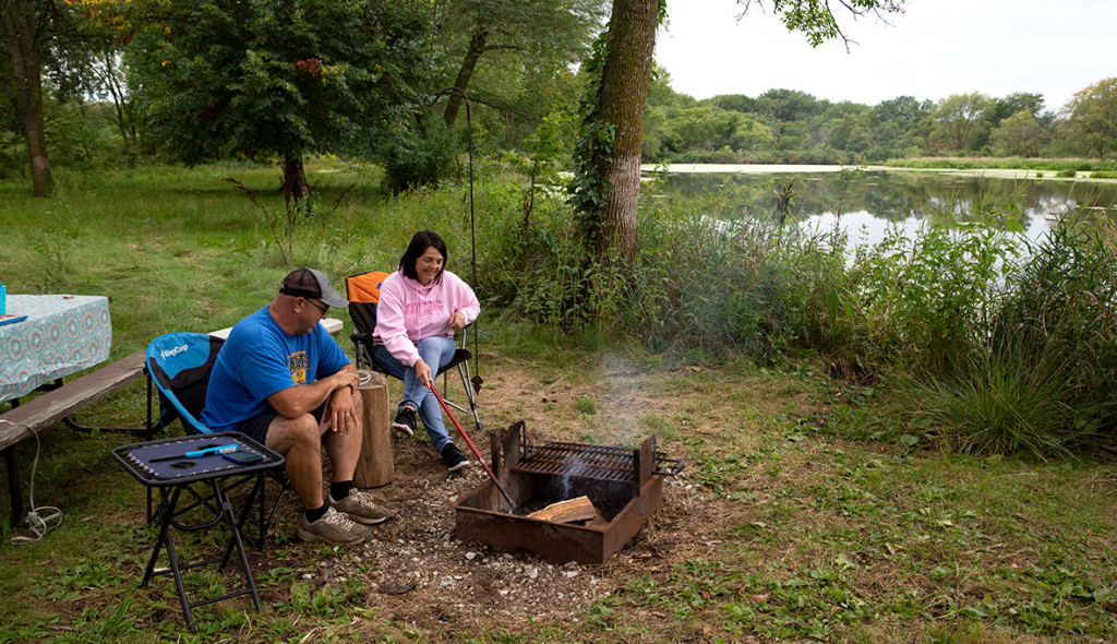Shelly and Dave Dahl, of Scribner, prepare a fire while RV camping at Dead Timber.