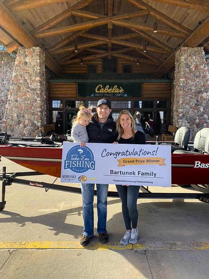 Mitch and Heather Bartunek introduced their 2-year-old daughter, Tinley, to fishing this year. Now that they have won the grand prize in the 2021 Take ’em Fishing program, they can take her fishing next year in their new Bass Tracker Classic XL fishing boat courtesy of Bass Pro Shops and Cabela’s. (Nebraska Game and Parks Commission)