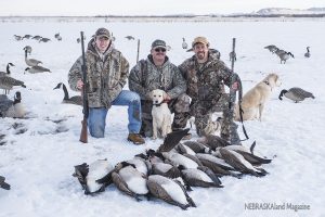 Hunters with their geese.