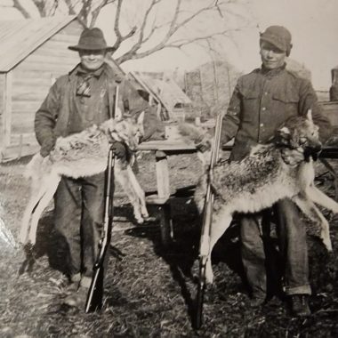 Vintage photo of two men with harvested coyotes in Nebraska.