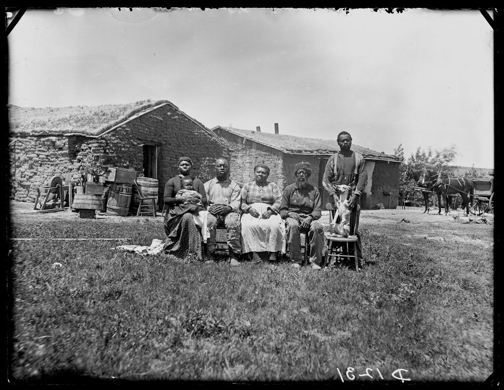 An African American family poses outside their settlement in Custer County, Nebraska in 1887.