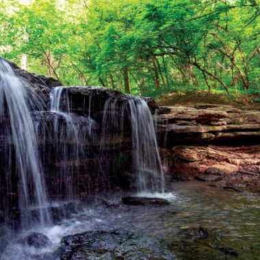 Stone Creek Falls at Platte River State Park during summer.