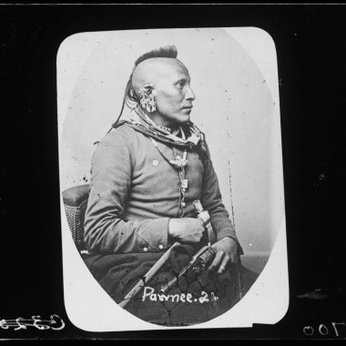 A black and white photo of a Native American man in a military uniform