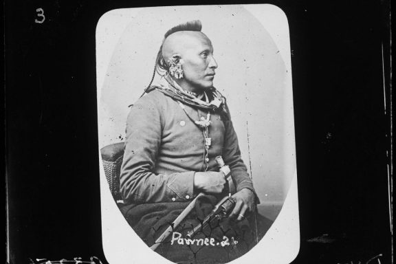 A black and white photo of a Native American man in a military uniform