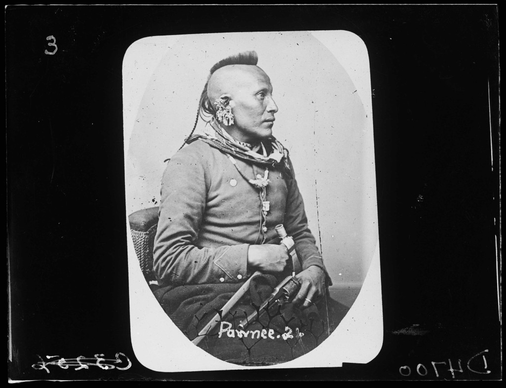 A black and white photo of a Native American man in a military uniform