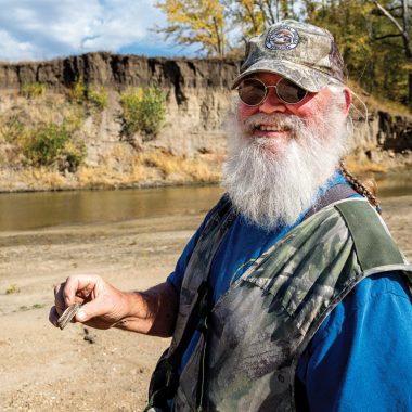 A man finds an Ice Age bison booth along the Big Nemaha River.