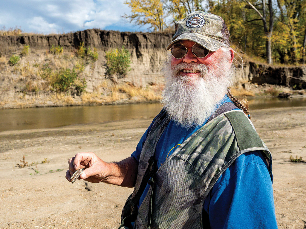 A man finds an Ice Age bison booth along the Big Nemaha River.