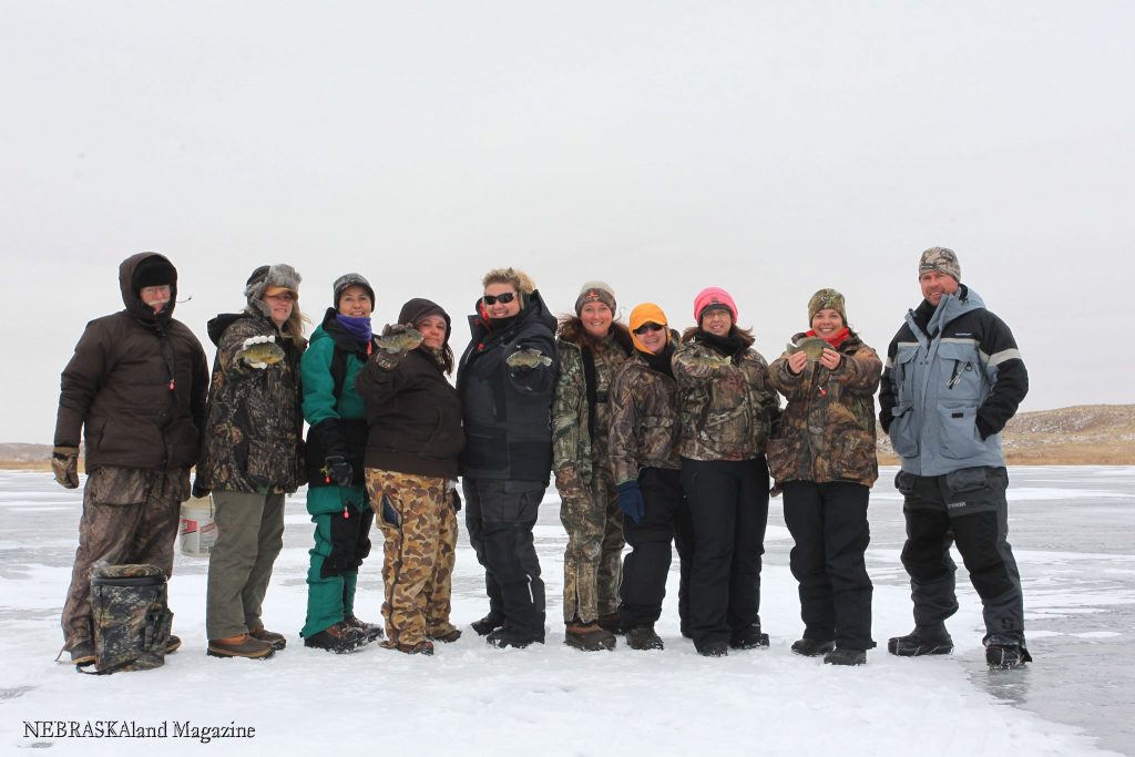 A group of people ice fishing.