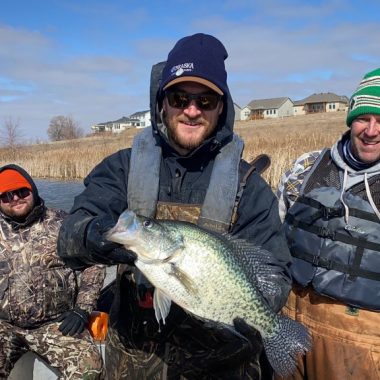 Fisheries biologists catch a giant crappie while tagging pike.