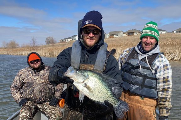 Fisheries biologists catch a giant crappie while tagging pike.