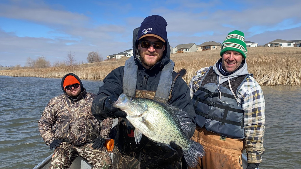 Fisheries biologists catch a giant crappie while tagging pike.