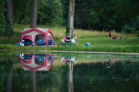 a family camps by a lake