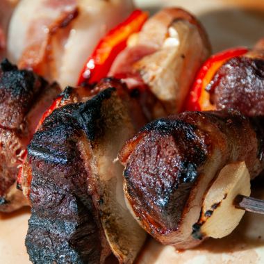 Canada goose grilled with onions and bell peppers and bacon.