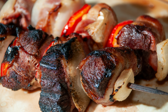 Canada goose grilled with onions and bell peppers and bacon.