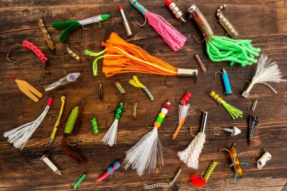 A collection of homemade fishing lures displayed on a table.