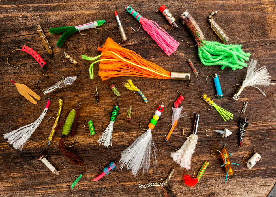 A collection of homemade fishing lures displayed on a table.