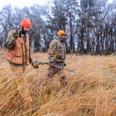 Two men hunting pheasants.