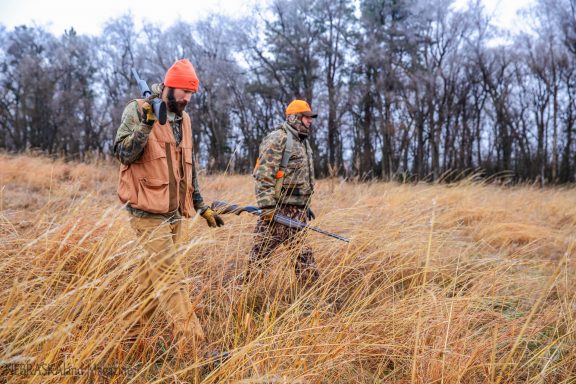 Two men hunting pheasants.