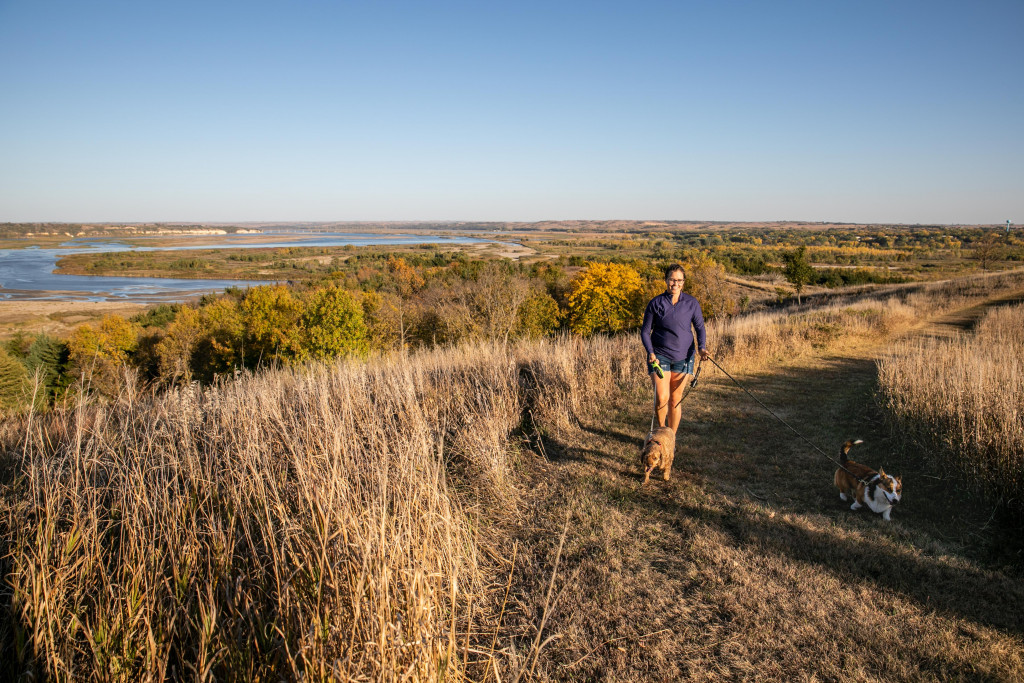 A woman walking dogs on the trail at Niobrara State Park.