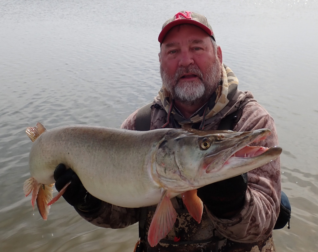 a man holding a muskie