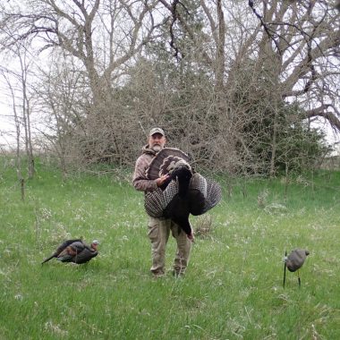 Daryl Bauer carrying a turkey.