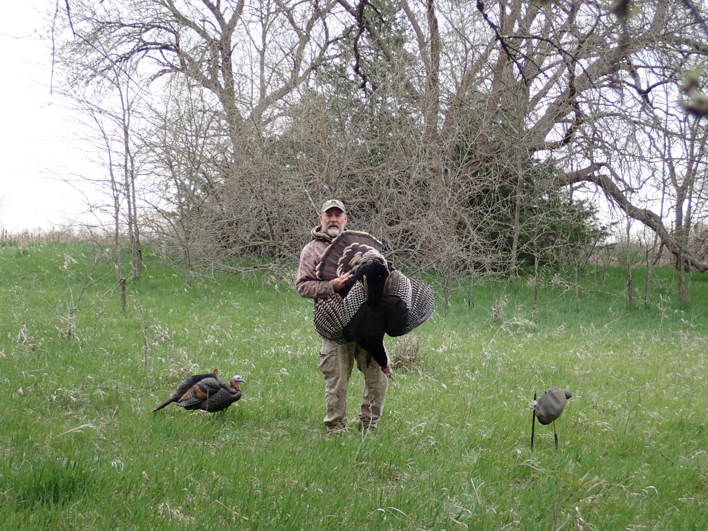 Daryl Bauer carrying a turkey.