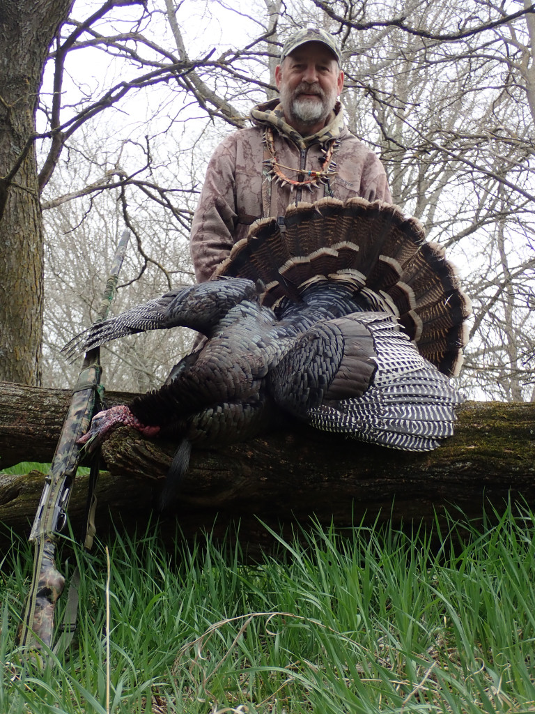 Daryl Bauer posing with a turkey.