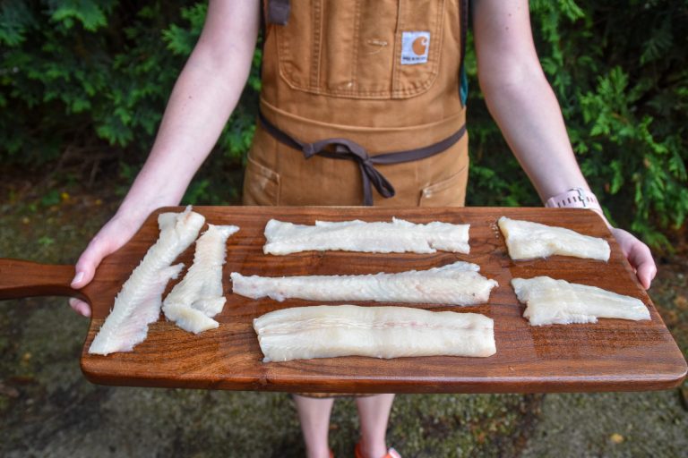 A cutting board with freshly fileted pike.