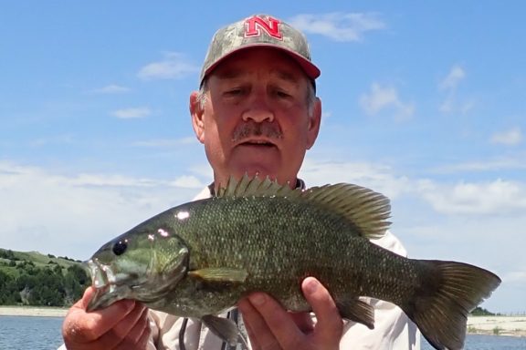 a man holding a smallmouth bass