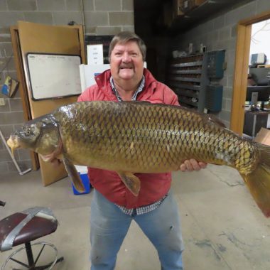 Man with 2023 state record common carp.