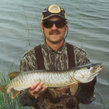 Daryl Bauer holding a tiger muskie.