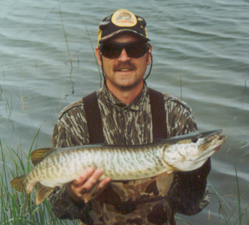 Daryl Bauer holding a tiger muskie.