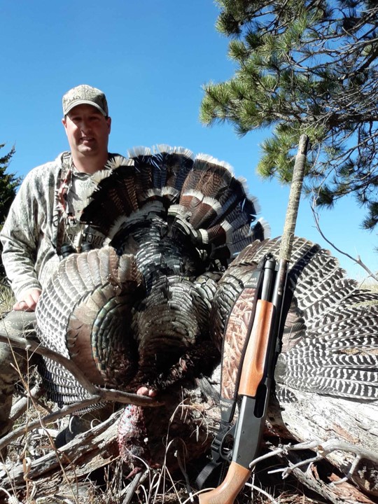 Daryl Bauer's son with a turkey.