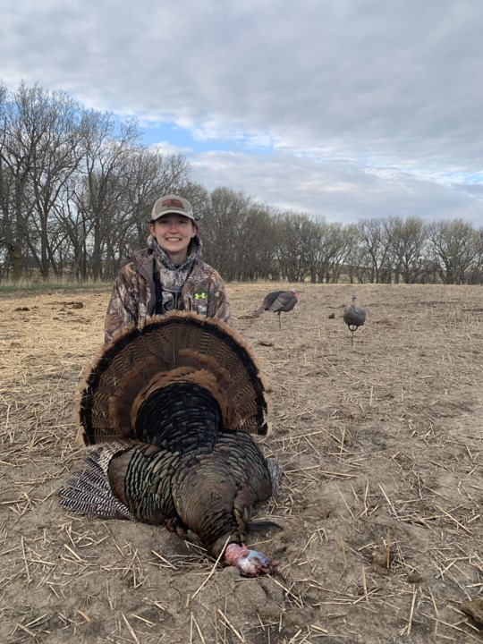 Daryl Bauer's daughter with a turkey.