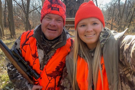 A man and his daughter deer hunting in a forest in Nebraska in November.