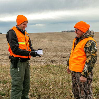 A Nebraska Game and Parks conservation officer checks a deer hunter for his permit during the November deer rifle season.