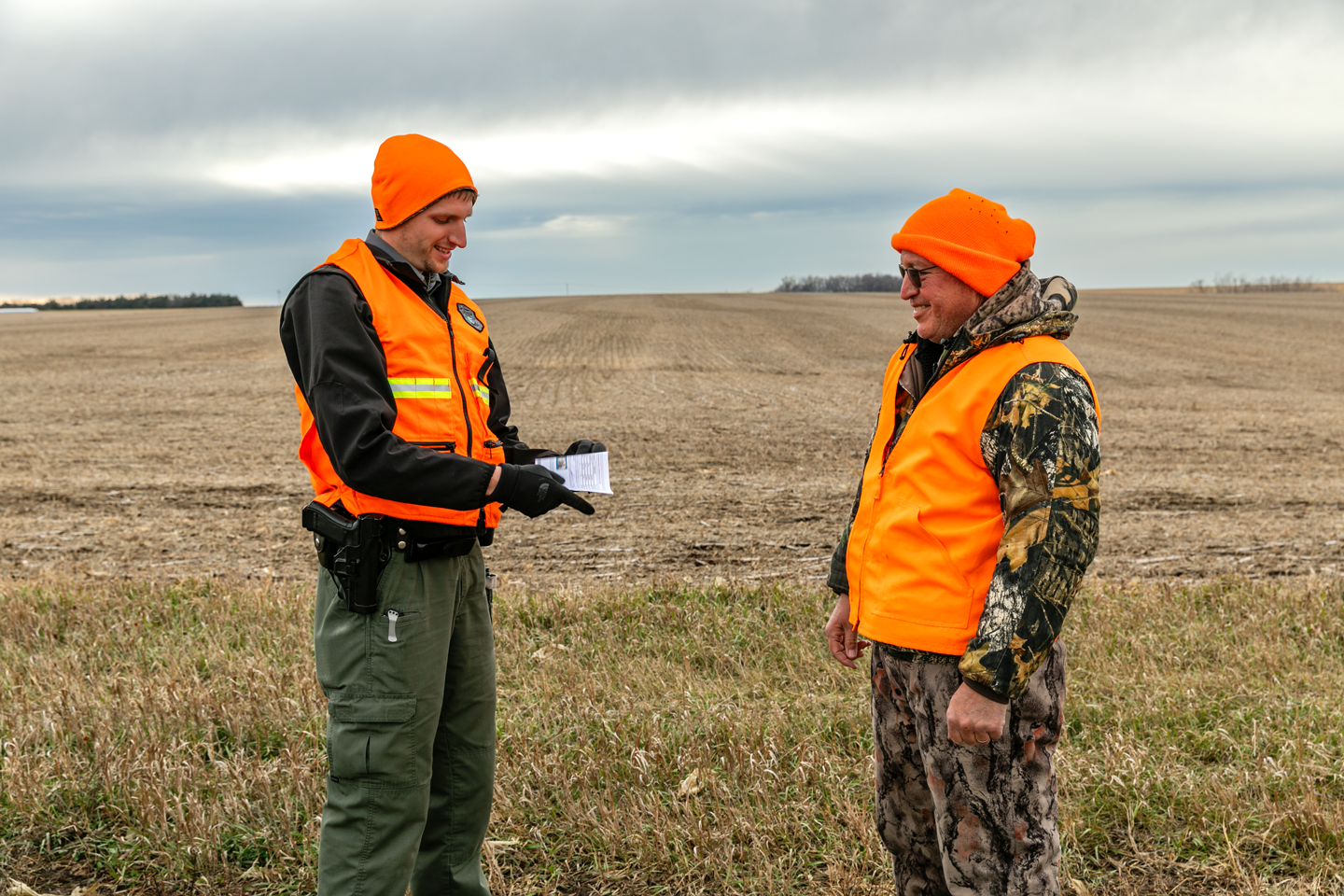 A Nebraska Game and Parks conservation officer checks a deer hunter for his permit during the November deer rifle season.