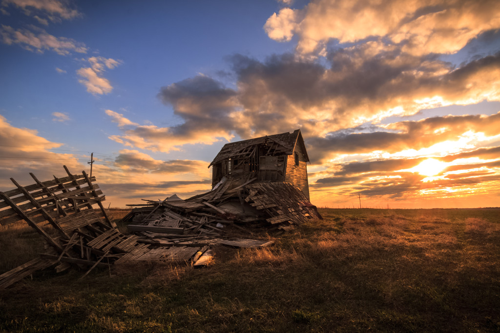 A tattered barn at sunset on a warm afternoon.